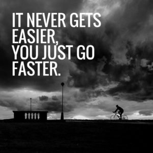 An image of a lone cyclist alongside a Greg LeMonde quote: it never gets easier, you just go faster